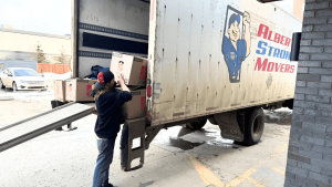 Alberta Strong Movers team handling boxes on moving day